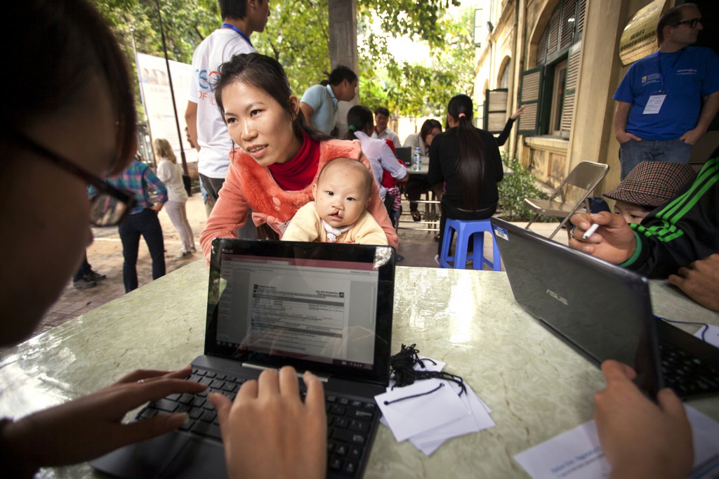 Patients in Hanoi are screened using a new electronic medical records system from partner Slainte Healthcare and 2-in-1 devices running Windows 8 donated by ASUS. (Photo by Zute Lightfoot, Operation Smile)