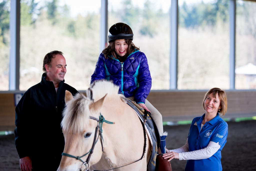 Microsoft employee Jeff Gollnick, left, volunteers at the Little Bit Therapeutic Riding Center. Photo: Scott Eklund/Red Box Pictures.