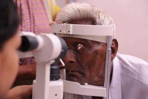 A man has his eyes screened in a rural village in Andhra Pradesh, India.