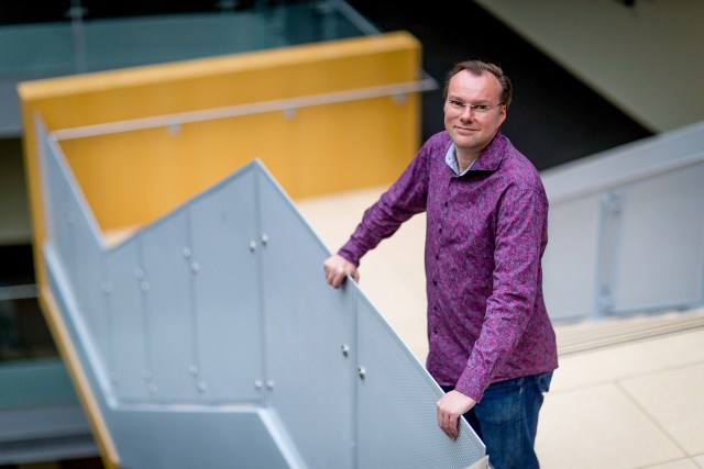 Photo of Frank Seide standing at the top of a stairway at Microsoft