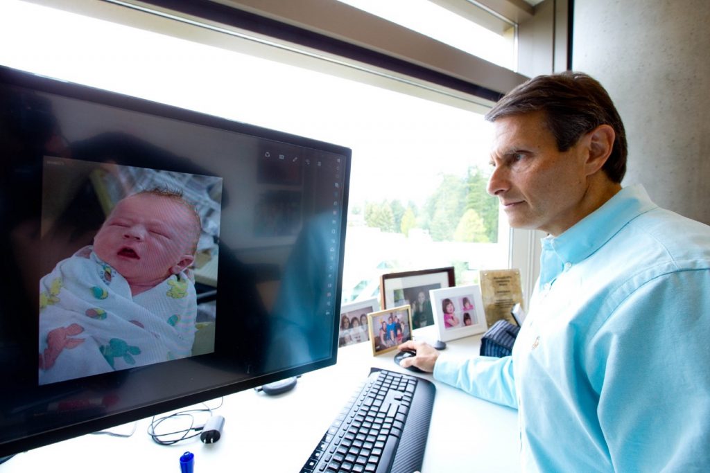 John Kahan in his office at Microsoft, with a photo of his son, Aaron, on the computer screen. (Photo by Scott Eklund/Red Box Pictures) Read more at https://blogs.microsoft.com/firehose/2017/06/07/a-gift-of-knowledge-that-could-help-save-the-lives-of-children-who-may-be-susceptible-to-sids/#4BeR8dfBrjwCJJIQ.99