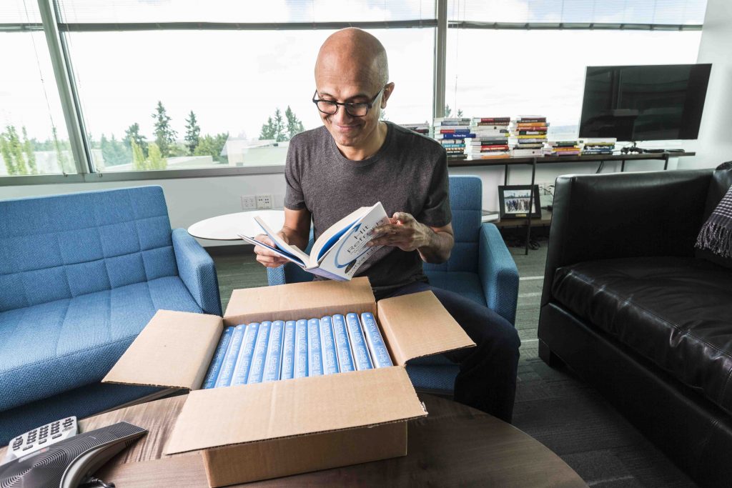 Microsoft SEO Satya Nadella in his office reading one of the first arrivals of his new book. 