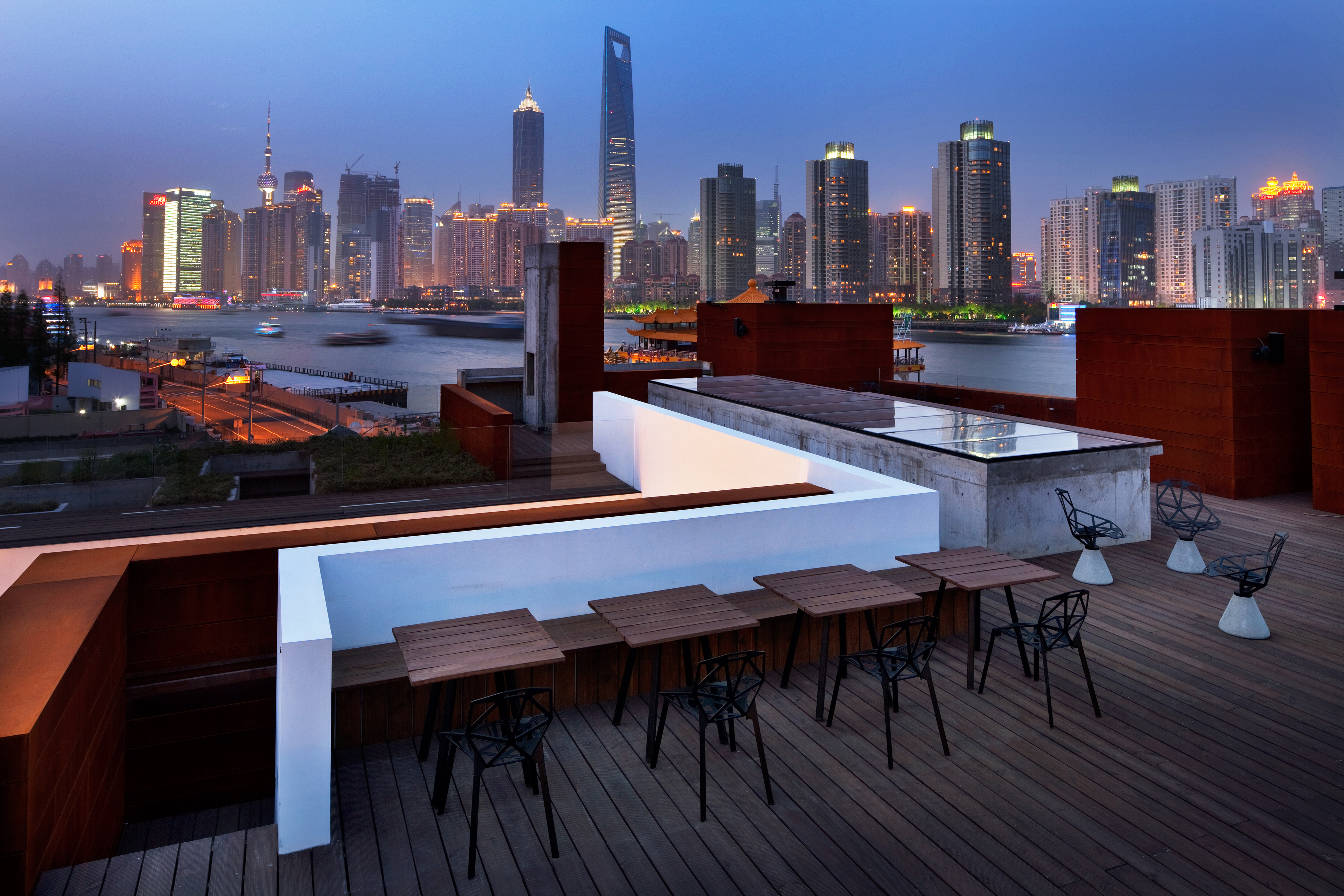 Photo of tables on a deck overlooking a city skyline