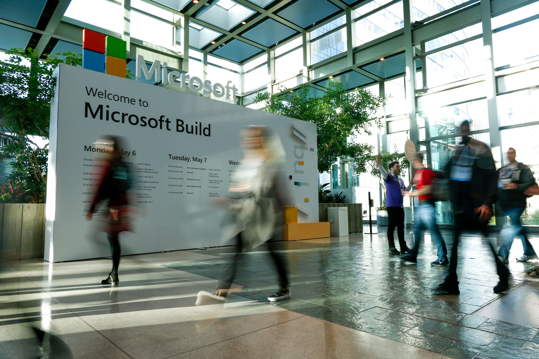 Photo of people walking by a sign that says Microsoft Build inside the Washington State Convention Center in Seattle