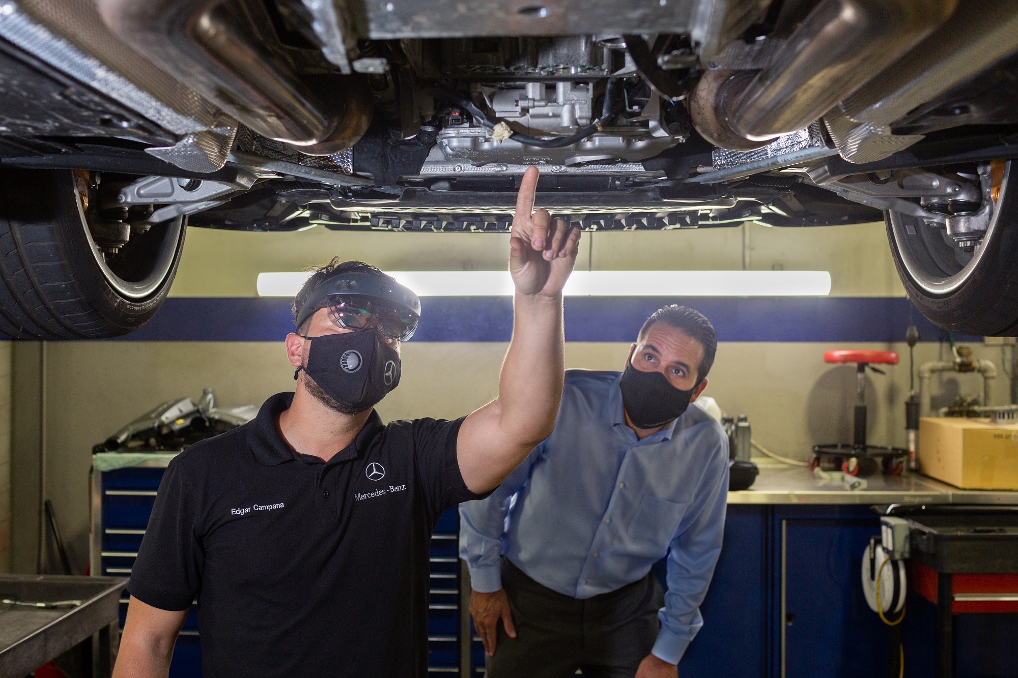 Mercedes-Benz USA technicians view the underside of a vehicle using HoloLens 2 headsets