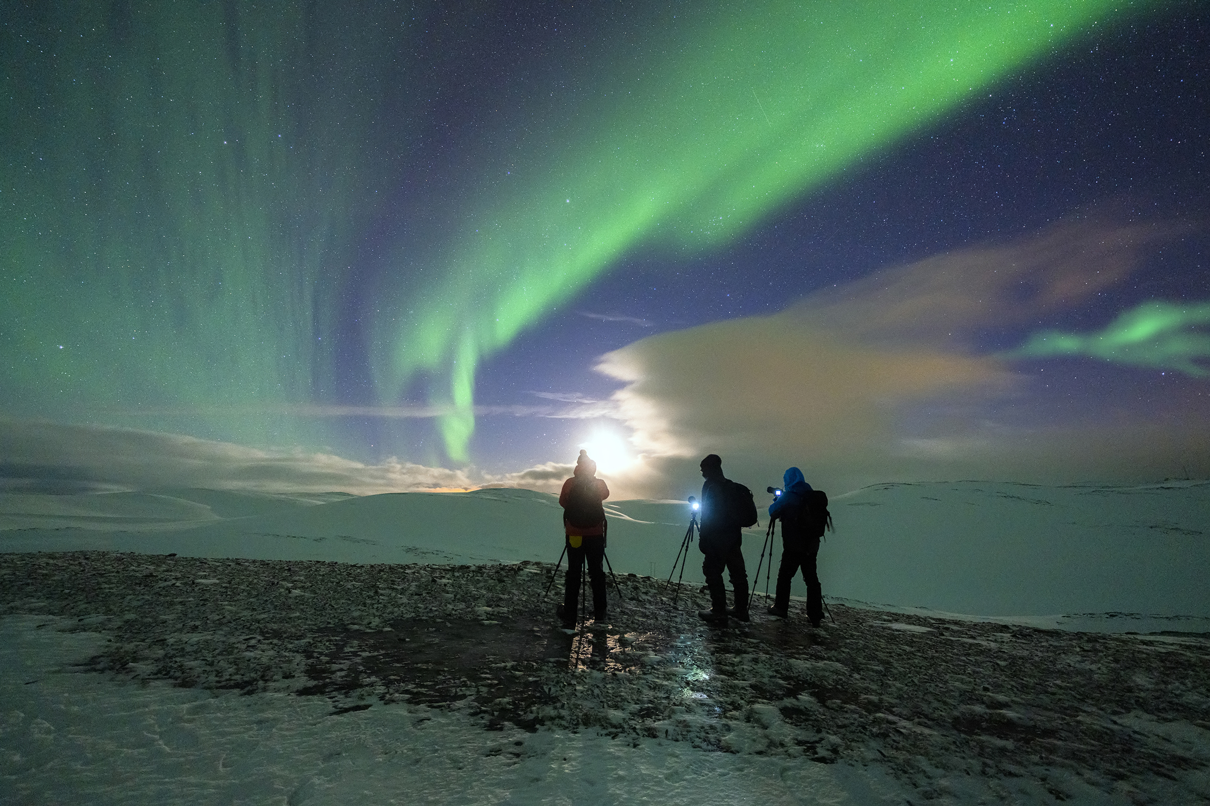 Three photographers admiring Northern Lights