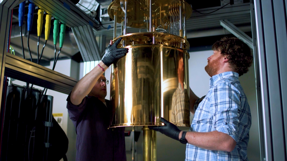 Two researchers working on a quantum machine.