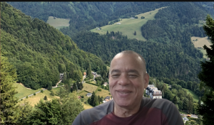 man taking a selfie in front of mountain