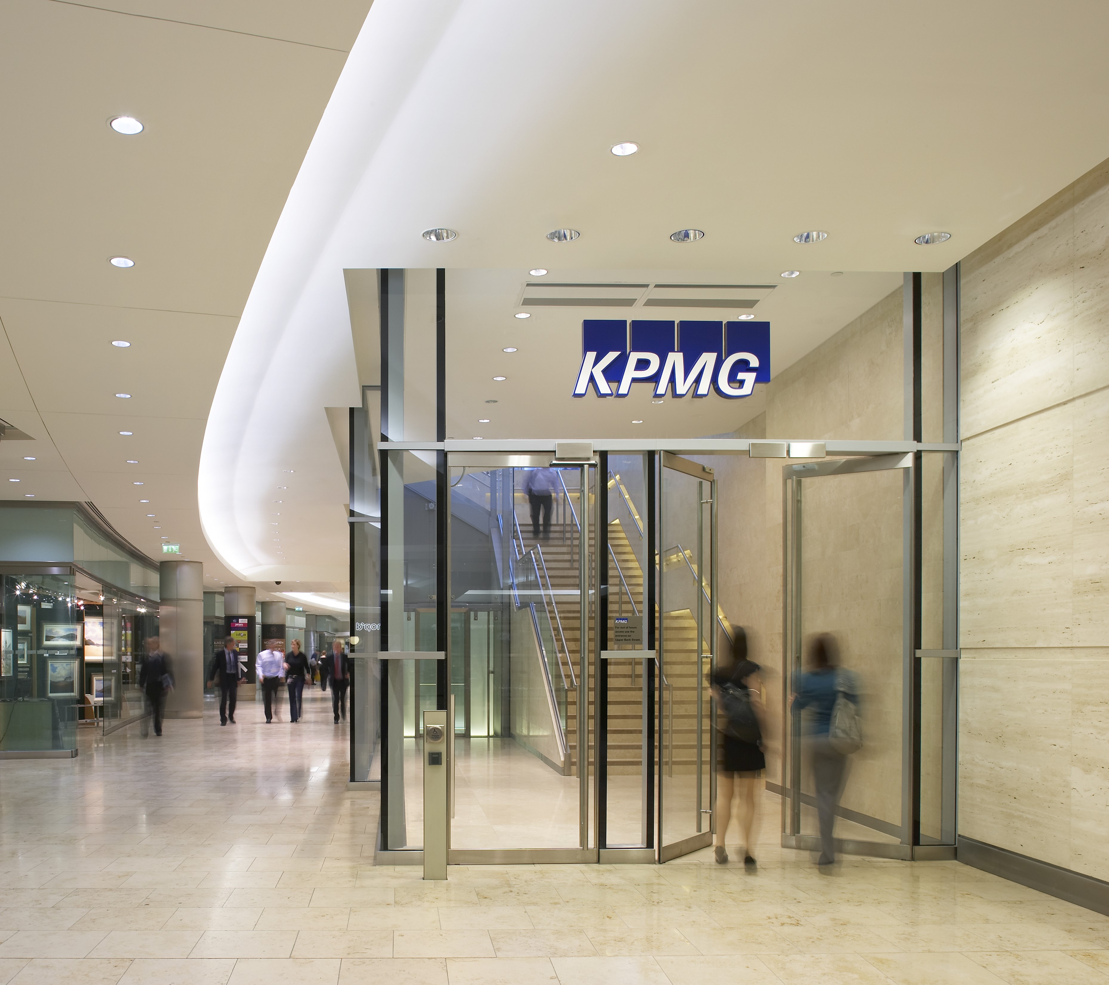 Two people entering a KPMG member firm.