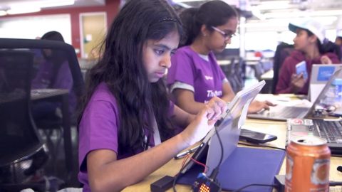 Young women work on touchscreens