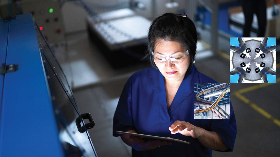 A woman looks at a tablet within a factory environment