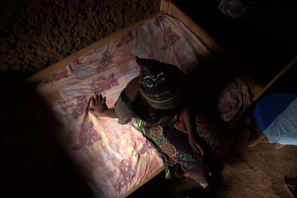 Elisabeth leans back on her bed as she tells her story of how she was trafficked at age 12. 