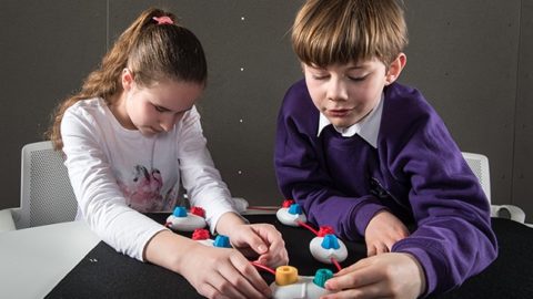 From left, Lexy Ryan, 13, and Theo Holroyd, 10, use Project Torino. The physical programming language is designed to be inclusive of children with visual impairments. Photo by Jonathan Banks.