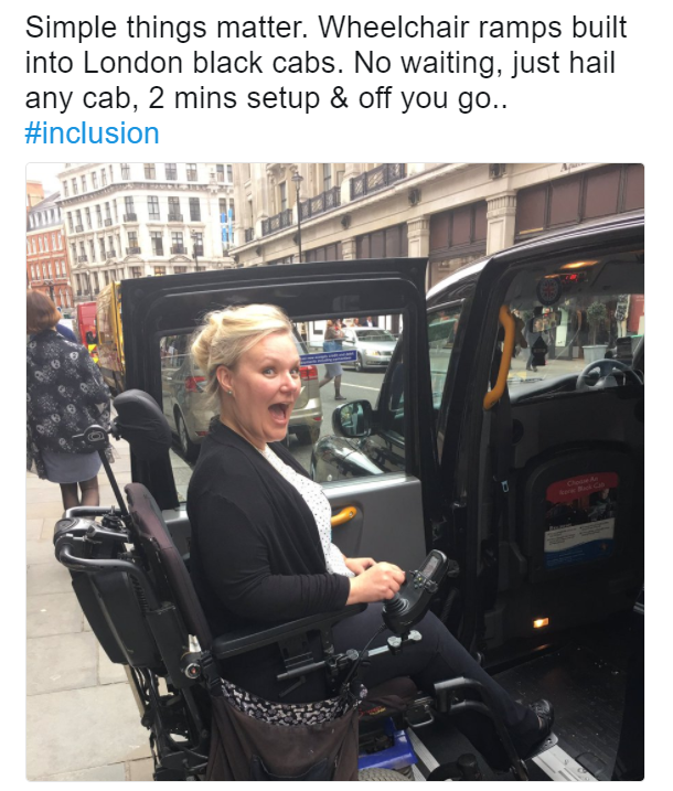 Jessica is looking excited while entering a wheelchair accessible taxi!