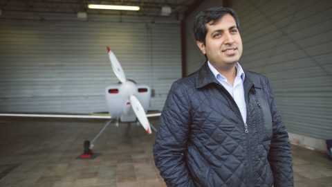 Ashish Kapoor standing in front of his airplane