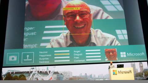 Chris Bishop, head of Microsoft Research Cambridge, demonstrates a new tool that recognizes emotion in pictures at Microsoft's Future Decoded conference.