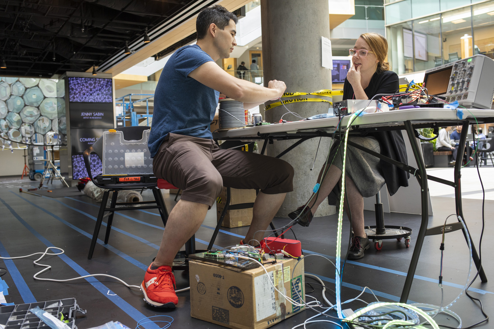 Asta Roseway and Jonathan Lester work with LED lights for "Ada" at Microsoft's Building 99 in Redmond, Wa.