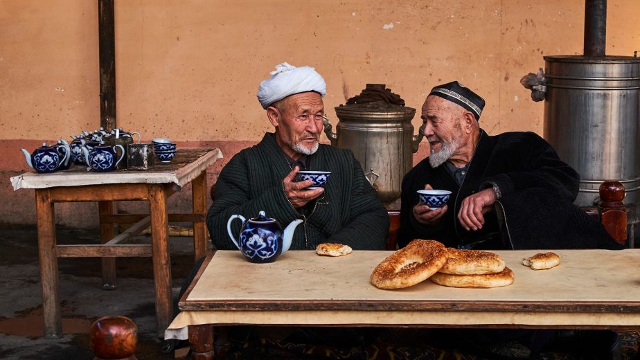 Two men drink tea in an Uzbekistan teahouse