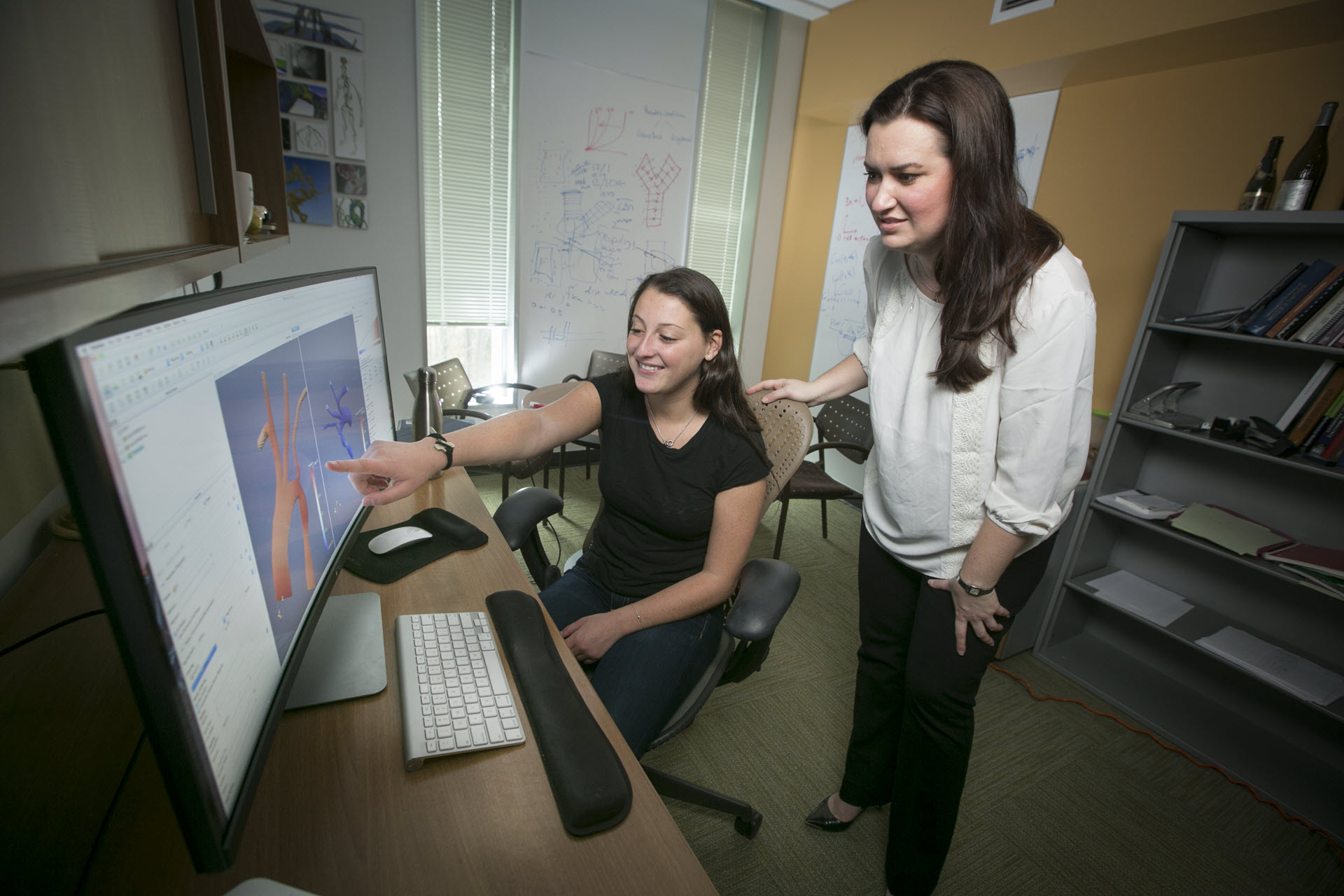 Amanda Randles and a co-worker collaborating at a computer.