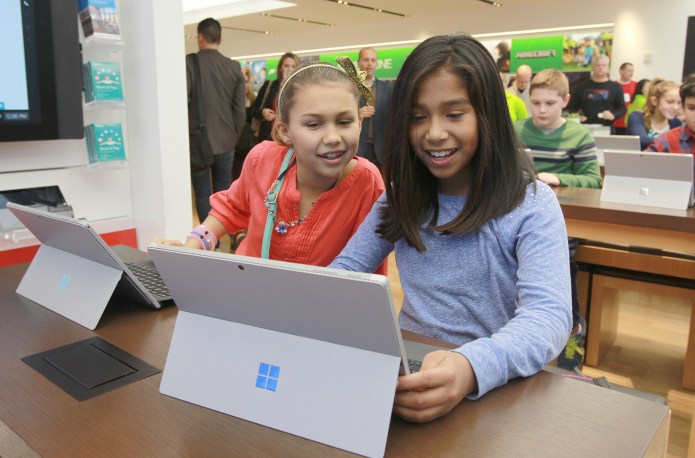 Two girls in Microsoft Store in New Jersey participating in the Minecraft Hour of Code tutorial.