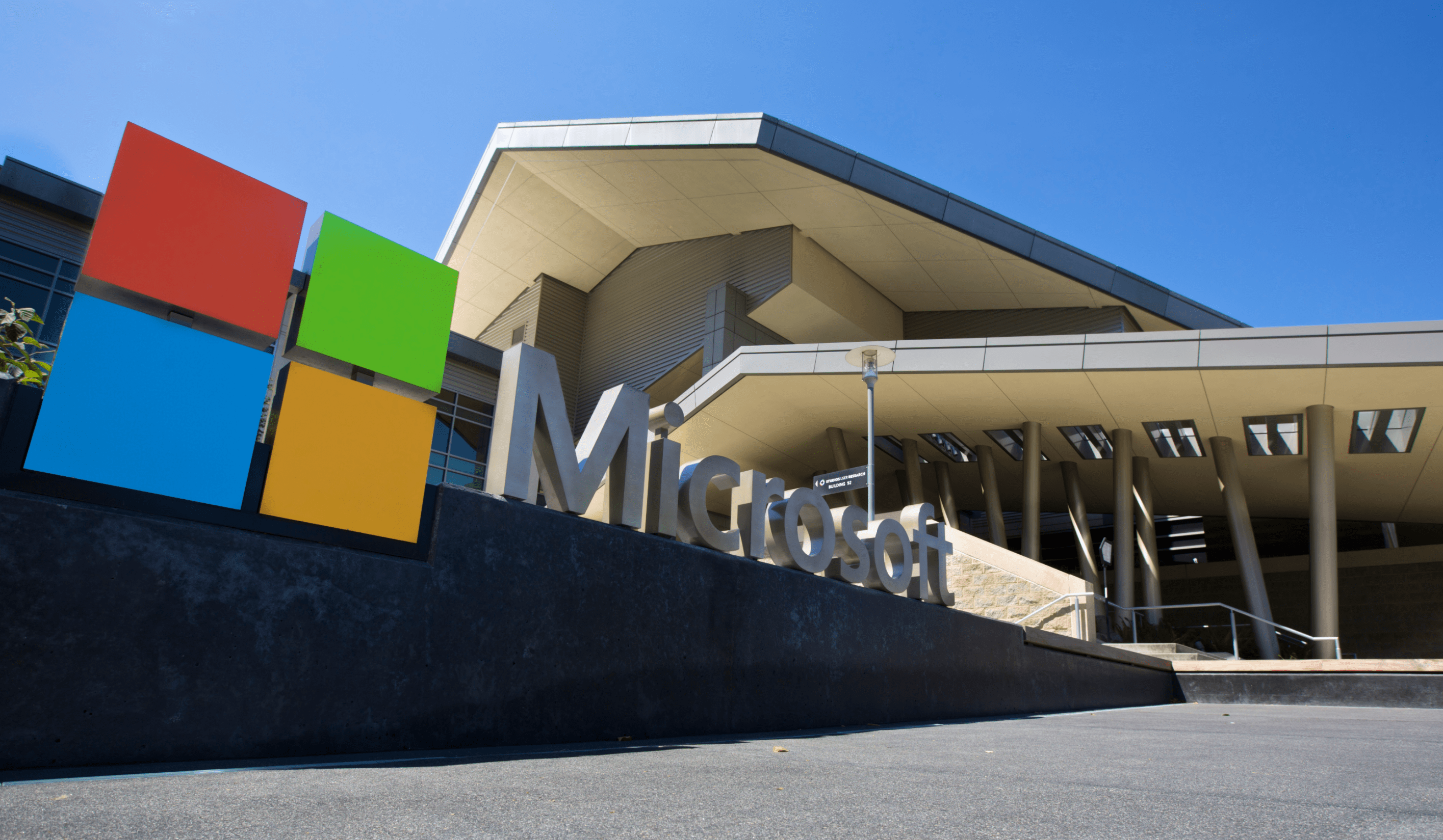 Photo of Microsoft sign with name and logo outside a building on the Redmond campus