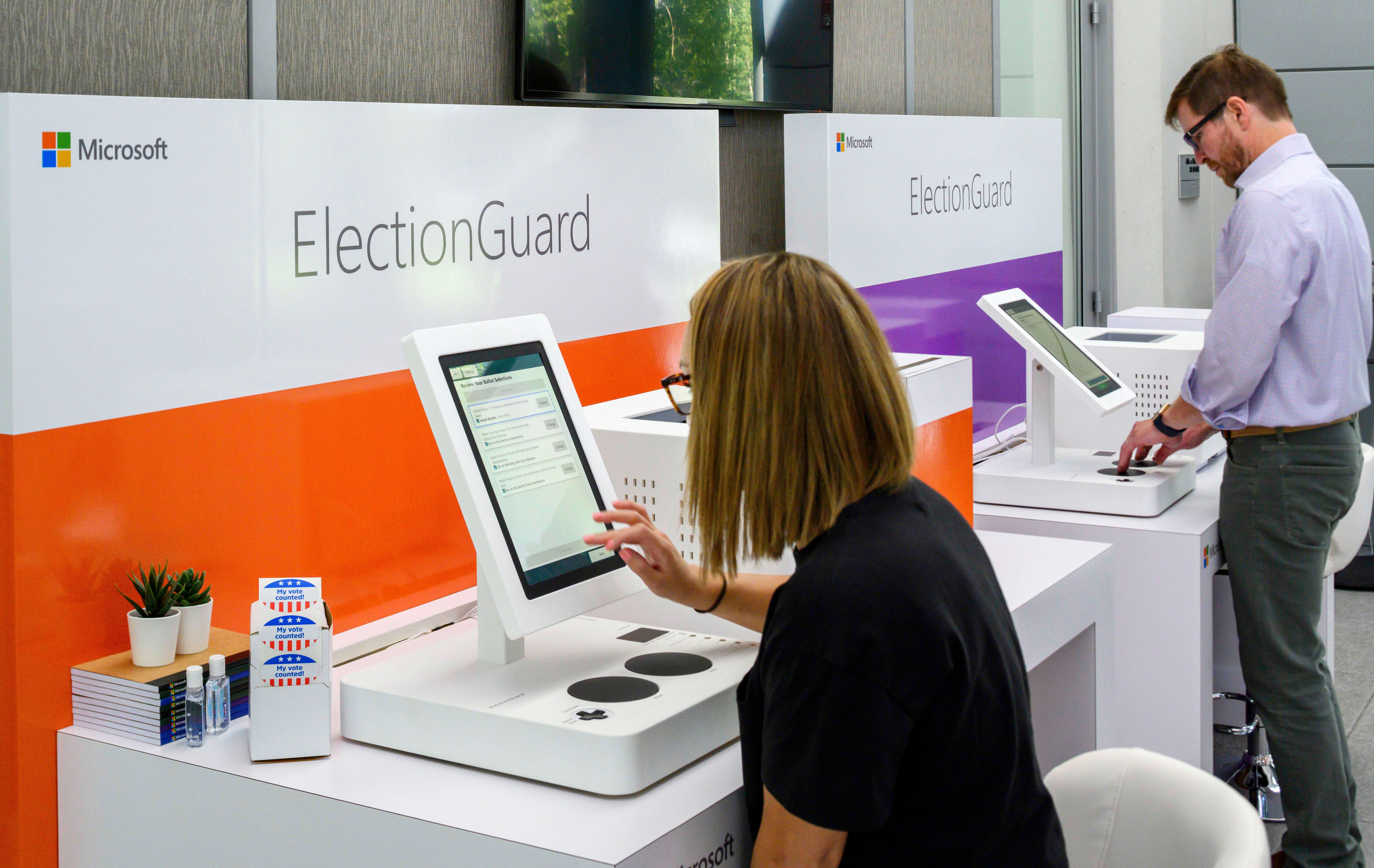 Man and woman look at Microsoft ElectionGuard demos