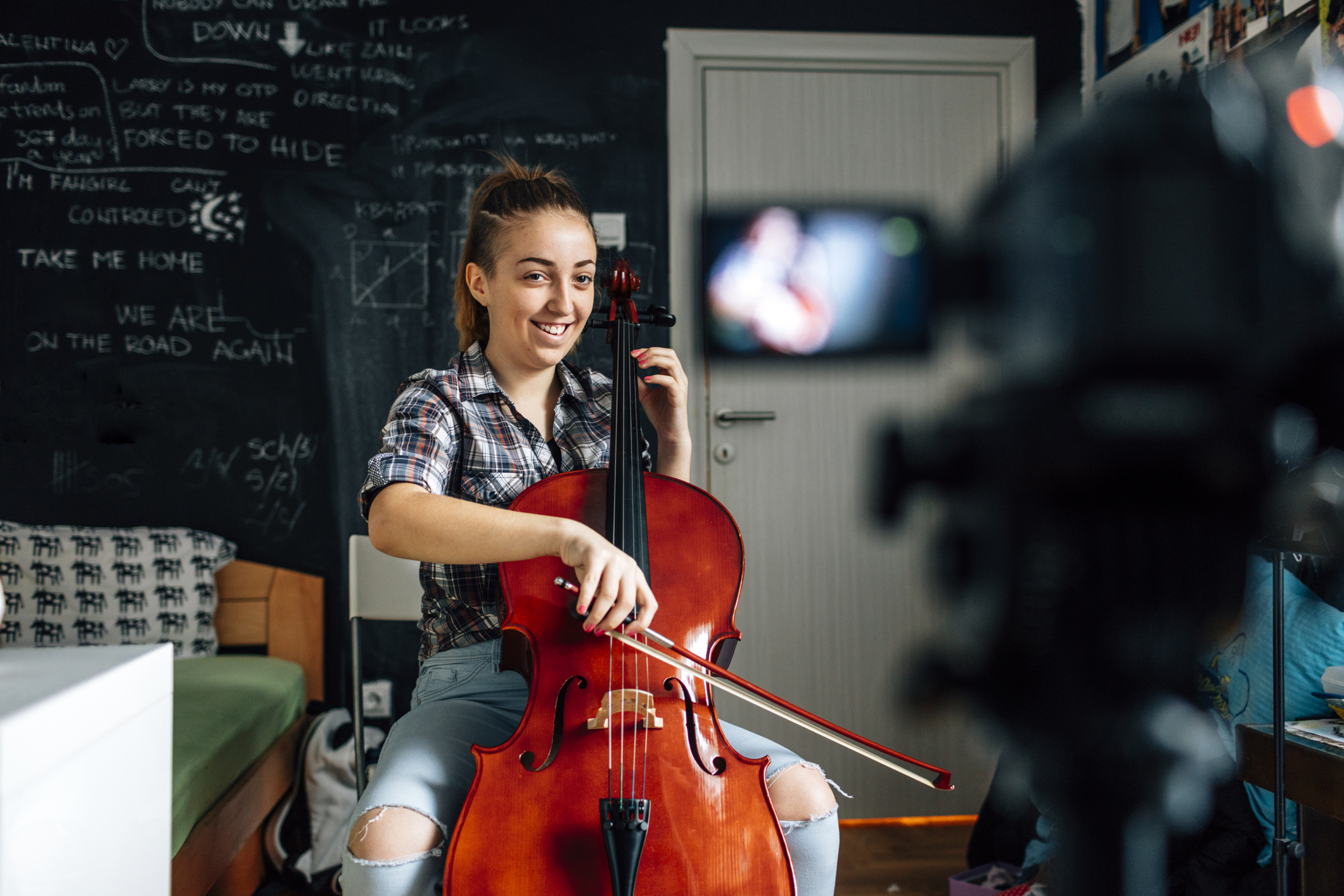 Smiling Teenage girl playing cello