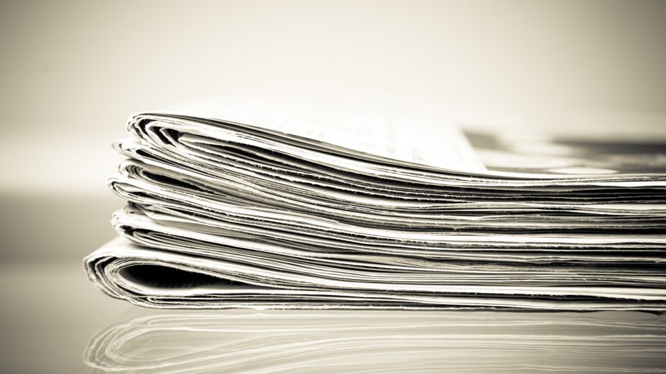 a close up of a stack of newspapers