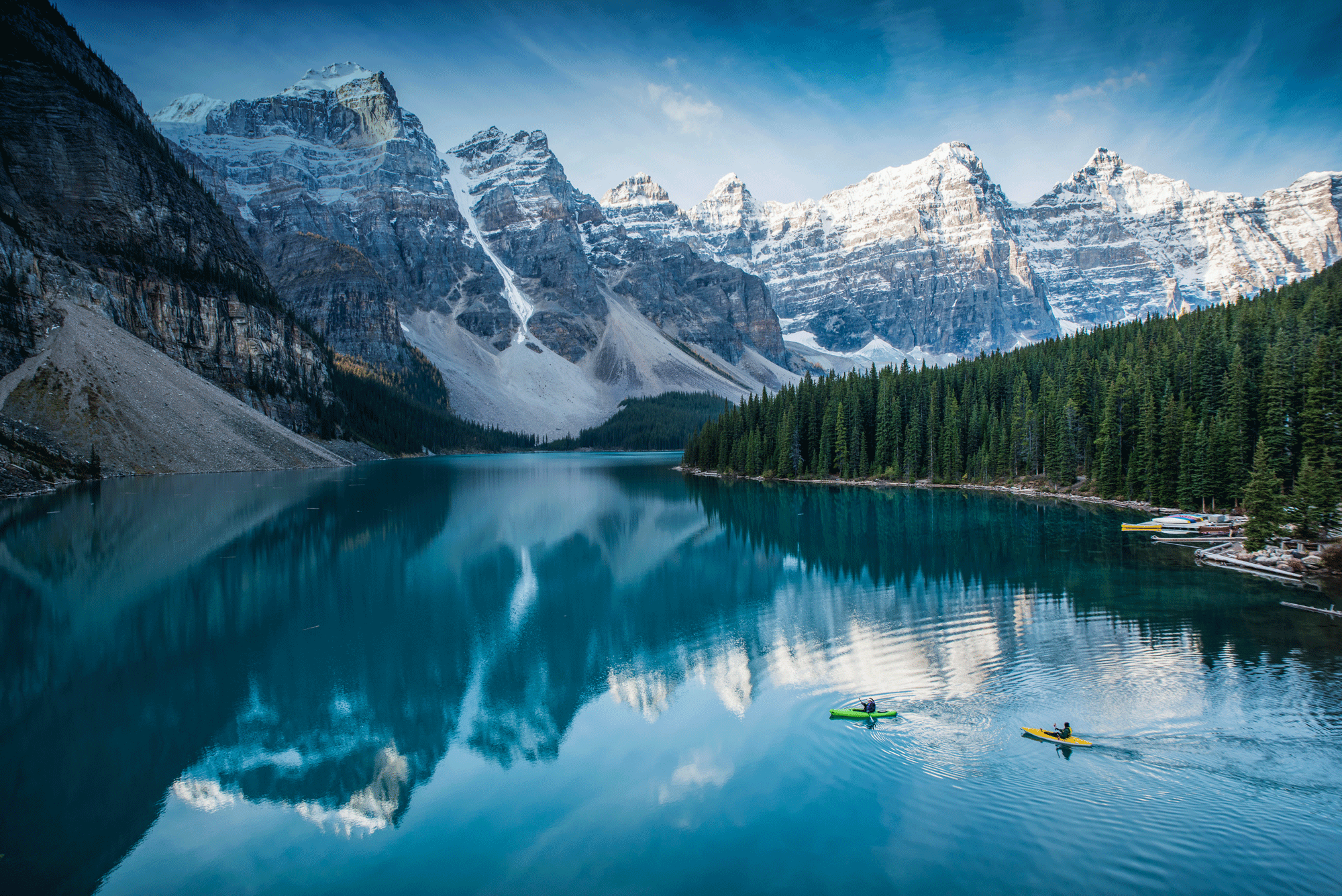 Canoers on a pictureque lake with a mountain backdrop