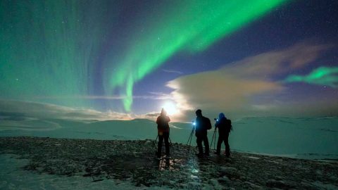 Photographers admiring the Northern Lights in the cold winter night, Honningsvag, Nordkapp, Troms og Finnmark, Northern Norway. Getty Images/Roberto Moiola